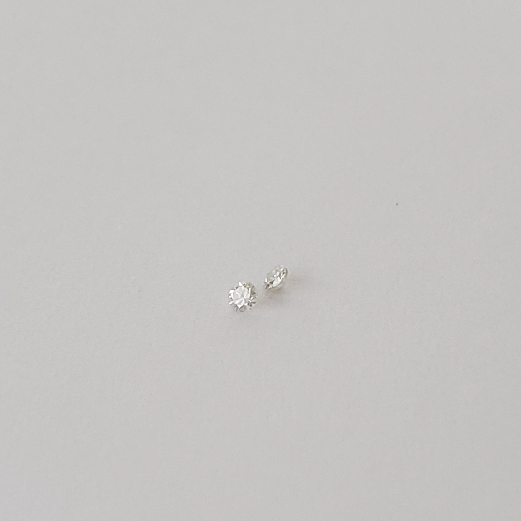  Pair of Moissanite | Round Diamond Cut | White | 1.2mm | SO24 2
